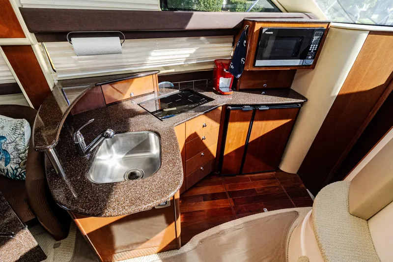  Yacht Photos Pics Luxurious 2009 Meridian 391 Sedan yacht kitchen with sink, stove, and microwave.