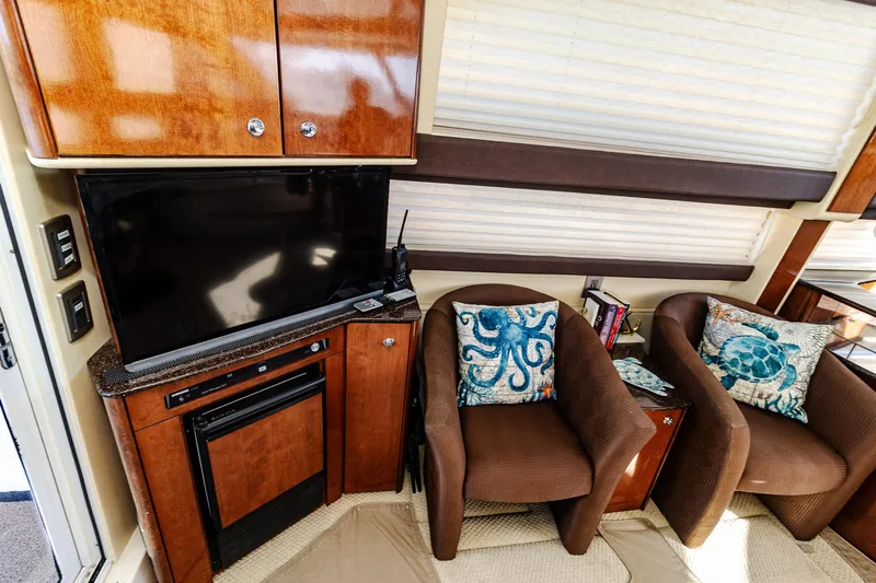  Yacht Photos Pics Interior of 2009 Meridian 391 Sedan with TV, chairs, and nautical-themed pillows.