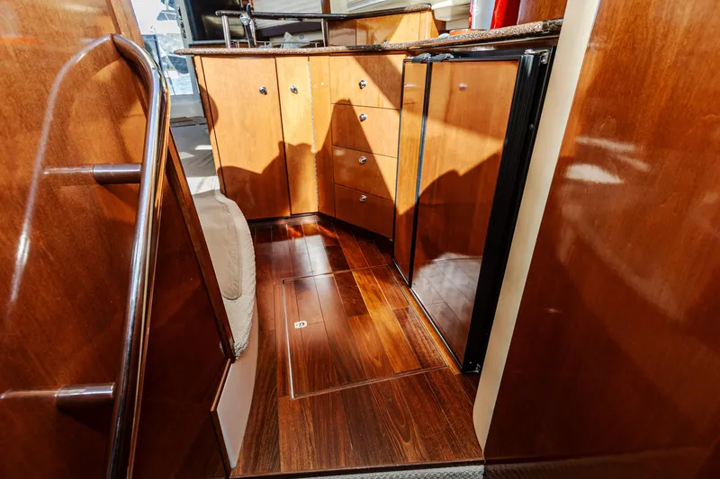  Yacht Photos Pics 2009 Meridian 391 Sedan interior with polished wood cabinetry and flooring.