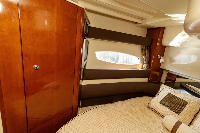  Yacht Photos Pics Luxurious interior of 2009 Meridian 391 Sedan yacht with cozy bed and wooden cabinetry.