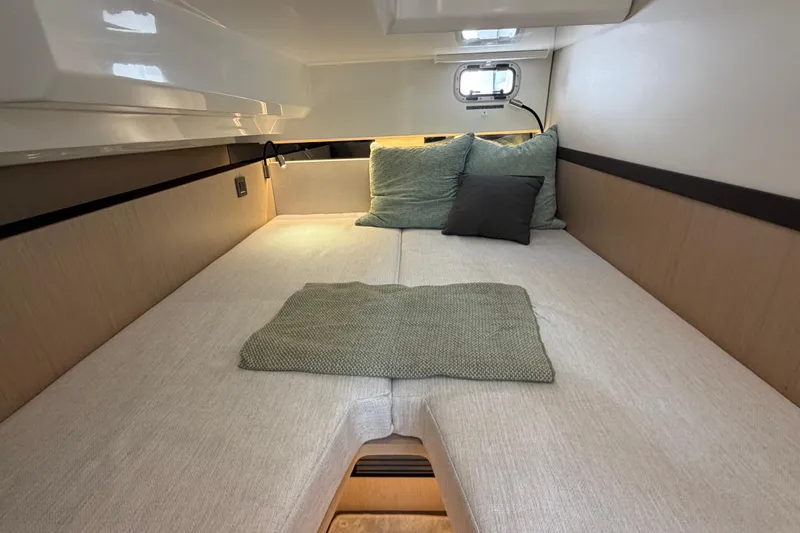  Yacht Photos Pics Cozy cabin interior of 2026 Jeanneau TH38 yacht with comfortable bedding.