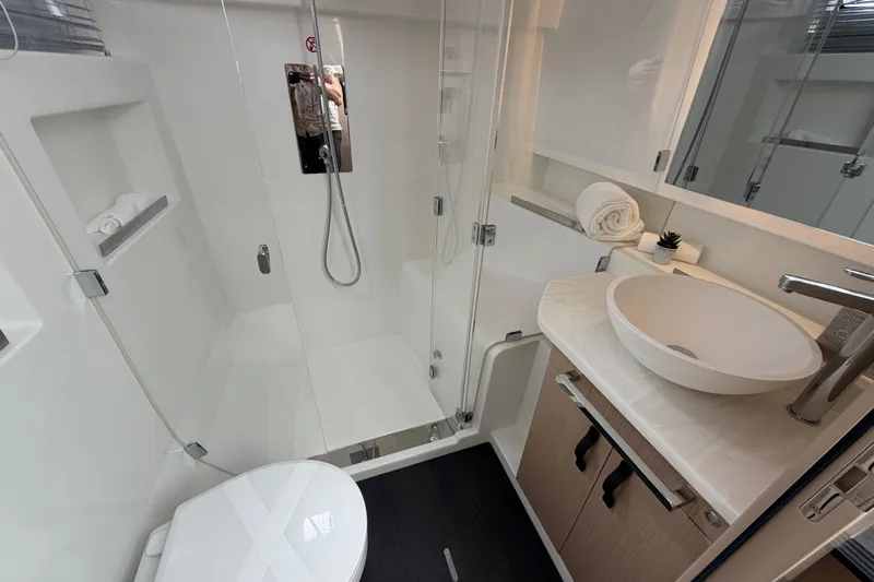  Yacht Photos Pics Modern bathroom in 2026 Jeanneau TH38 yacht with sleek fixtures and elegant design.