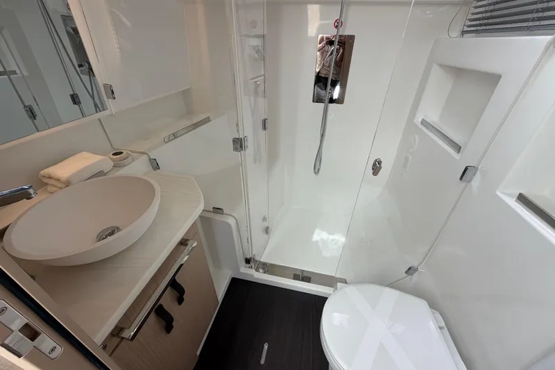  Yacht Photos Pics Modern bathroom in 2026 Jeanneau TH38 yacht with sleek fixtures and elegant design.