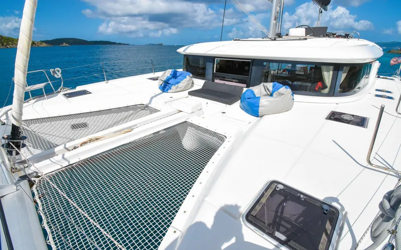 Celavie Yacht Photos Pics 2021 Lagoon 46 catamaran on open water, featuring spacious deck and netting.