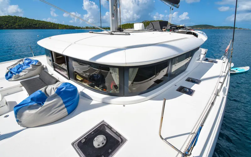 Celavie Yacht Photos Pics 2021 Lagoon 46 catamaran on serene blue water, featuring spacious deck and modern design.