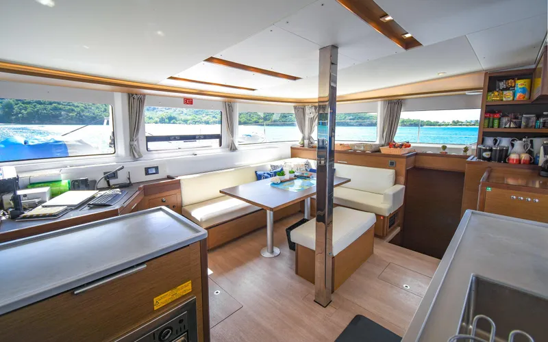Celavie Yacht Photos Pics Interior of 2021 Lagoon 46 catamaran with modern seating and panoramic windows.