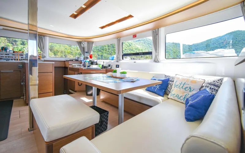 Celavie Yacht Photos Pics Luxurious interior of 2021 Lagoon 46 catamaran with spacious seating and scenic views.