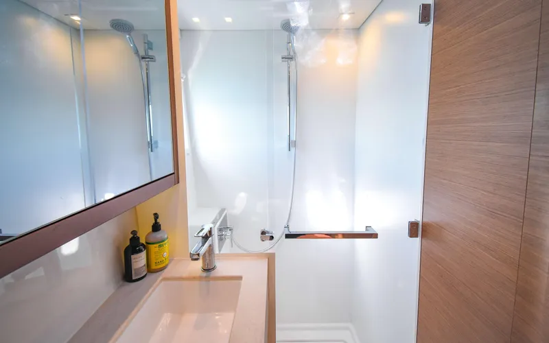 Celavie Yacht Photos Pics Modern bathroom in 2021 Lagoon 46 yacht with sleek shower and vanity.