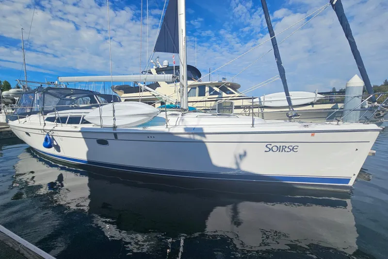 Soirse Yacht Photos Pics 2013 Marlow-Hunter 50 aft cabin sailboat docked under blue sky.