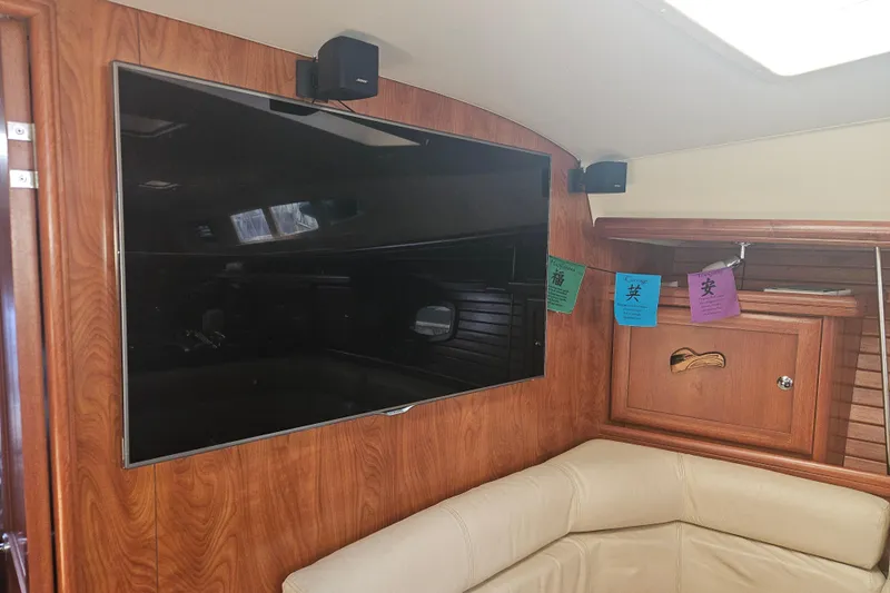 Soirse Yacht Photos Pics Interior of 2013 Marlow-Hunter 50 aft cabin with TV and wood paneling.