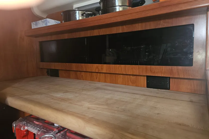 Soirse Yacht Photos Pics Wooden interior of 2013 Marlow-Hunter 50 aft cabin with countertop and storage.