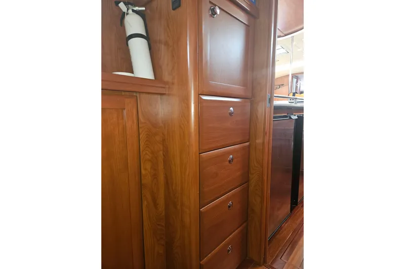 Soirse Yacht Photos Pics Wooden cabinetry and fire extinguisher in 2013 Marlow-Hunter 50 aft cabin interior.