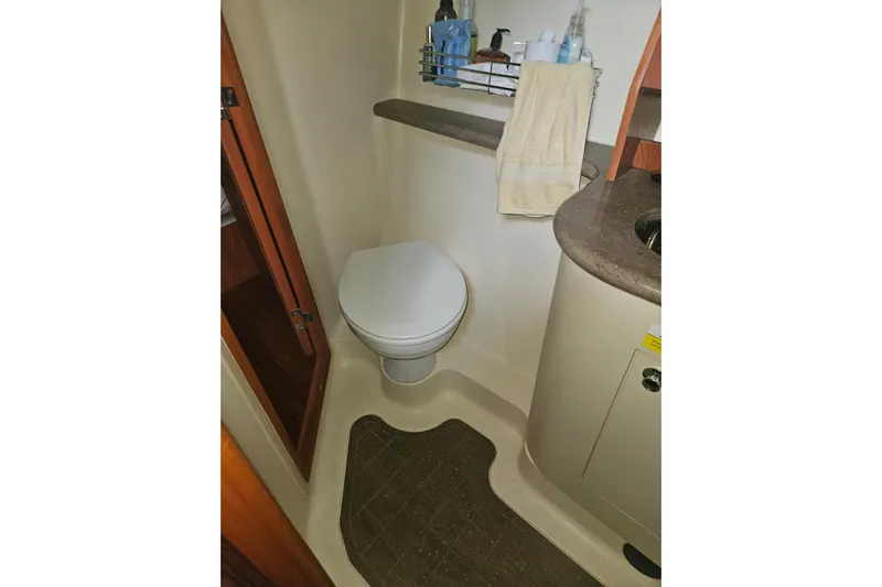 Soirse Yacht Photos Pics 2013 Marlow-Hunter 50 aft cabin bathroom with toilet, sink, and storage shelves.