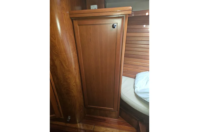 Soirse Yacht Photos Pics Wooden interior of 2013 Marlow-Hunter 50 aft cabin, featuring cabinetry and seating.