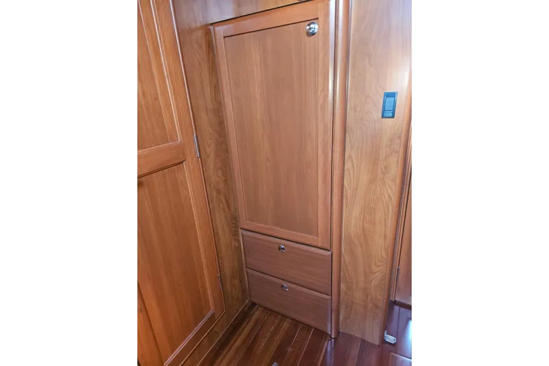 Soirse Yacht Photos Pics Wooden interior of 2013 Marlow-Hunter 50 aft cabin, featuring storage cabinets and drawers.