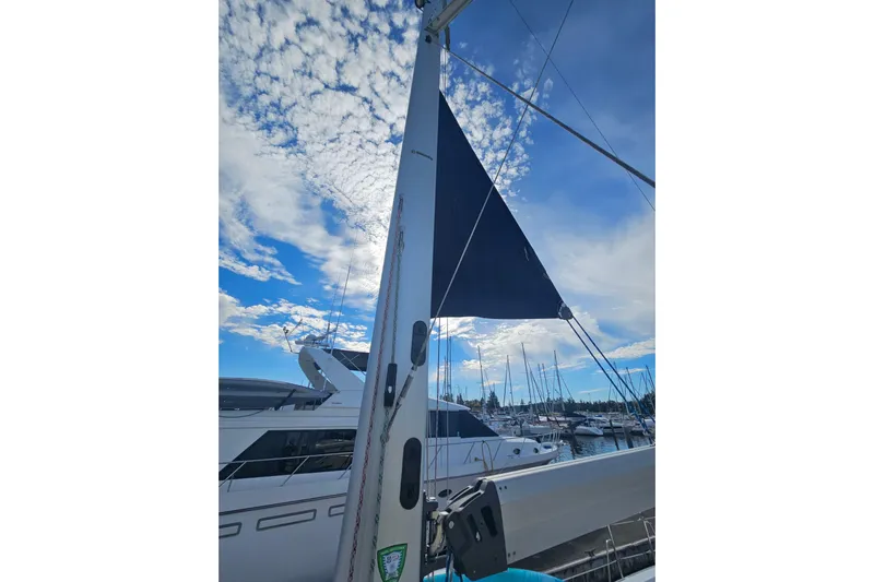 Soirse Yacht Photos Pics Sailboat mast and sail of 2013 Marlow-Hunter 50 aft cabin under blue sky.