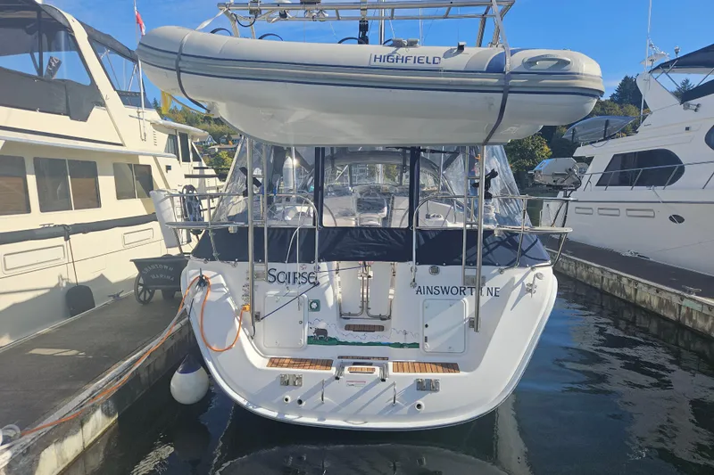 Soirse Yacht Photos Pics A 2013 Marlow-Hunter 50 aft cabin yacht docked, featuring a Highfield dinghy on top.