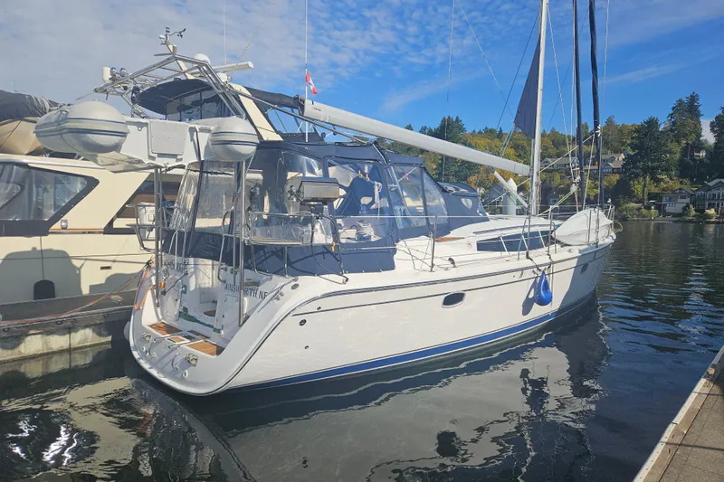 Soirse Yacht Photos Pics 2013 Marlow-Hunter 50 aft cabin yacht docked in a serene marina setting.