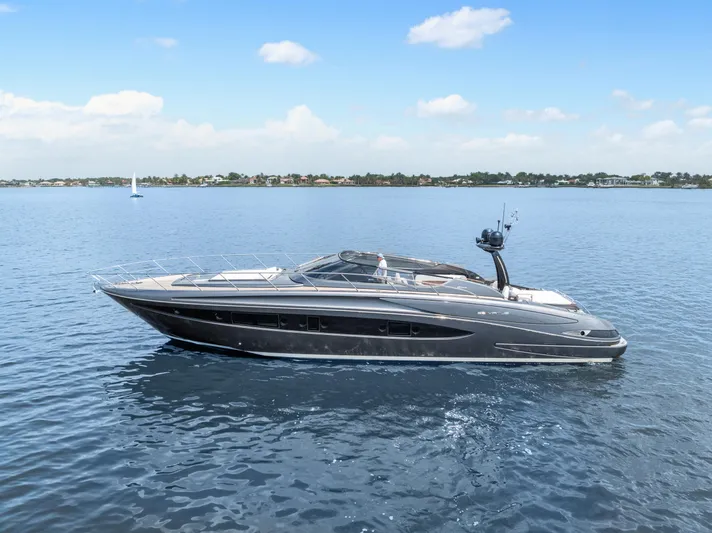 Wolverine Yacht Photos Pics 2015 Riva 63 Virtus yacht cruising on calm blue waters under a clear sky.