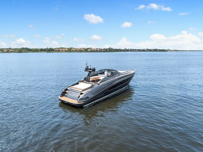 Wolverine Yacht Photos Pics 2015 Riva 63 Virtus yacht on calm water under a clear blue sky.