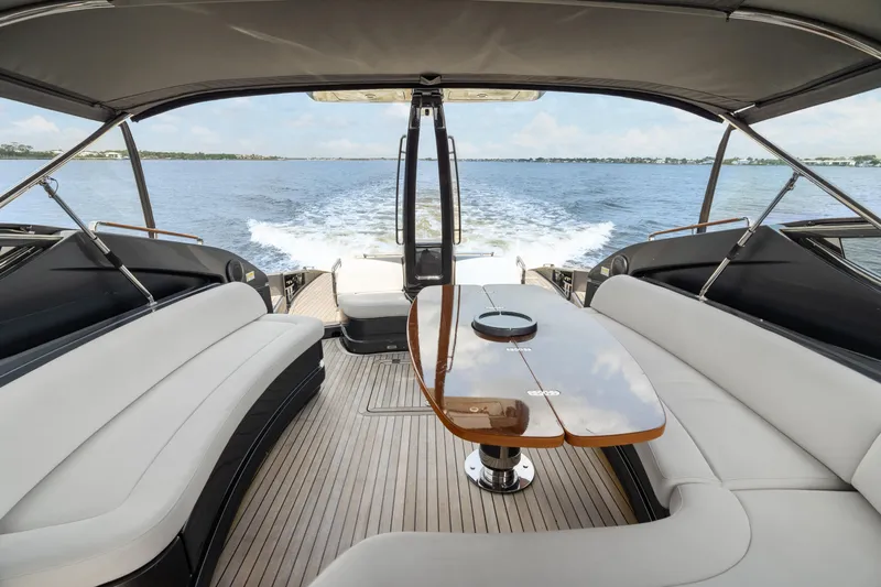 Wolverine Yacht Photos Pics Luxurious 2015 Riva 63 Virtus yacht interior with elegant seating and table, cruising on open water.