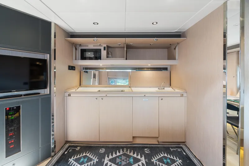 Wolverine Yacht Photos Pics Interior of 2015 Riva 63 Virtus yacht featuring a modern kitchenette and stylish decor.