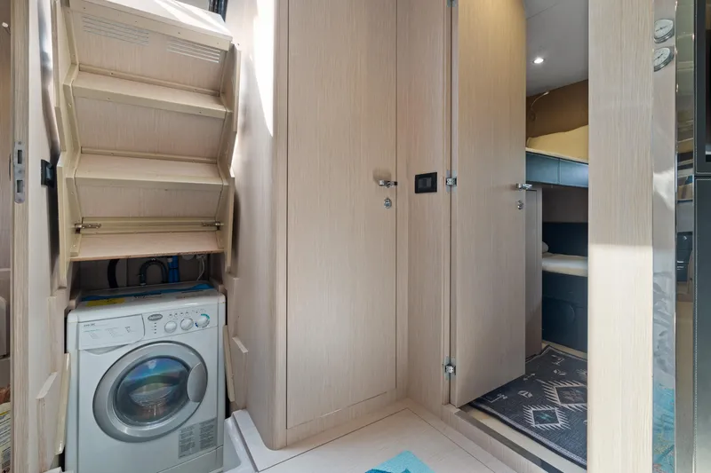 Wolverine Yacht Photos Pics Laundry area inside 2015 Riva 63 Virtus yacht with washing machine and storage.