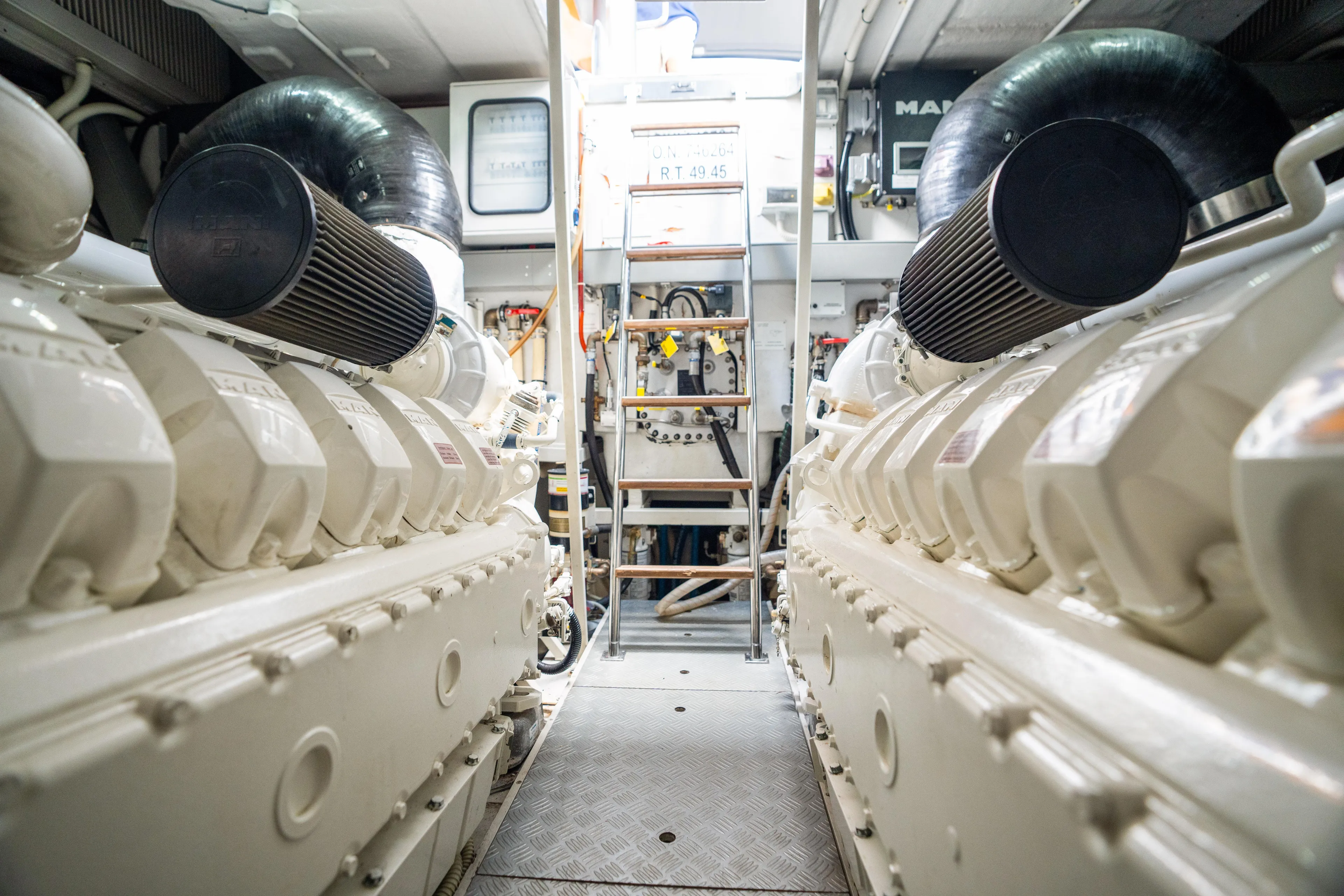 Wolverine Yacht Photos Pics Engine room of a 2015 Riva 63 Virtus yacht, showcasing dual engines and mechanical components.