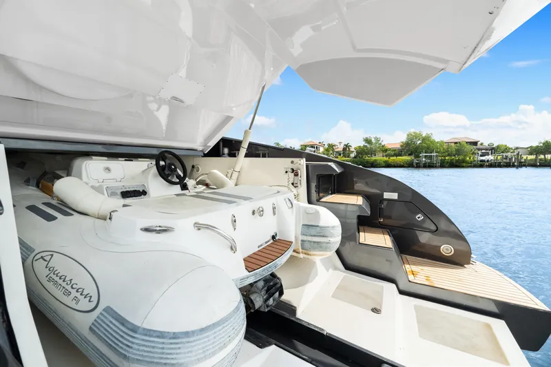 Wolverine Yacht Photos Pics 2015 Riva 63 Virtus yacht with Aquascan tender, docked by a scenic waterfront.