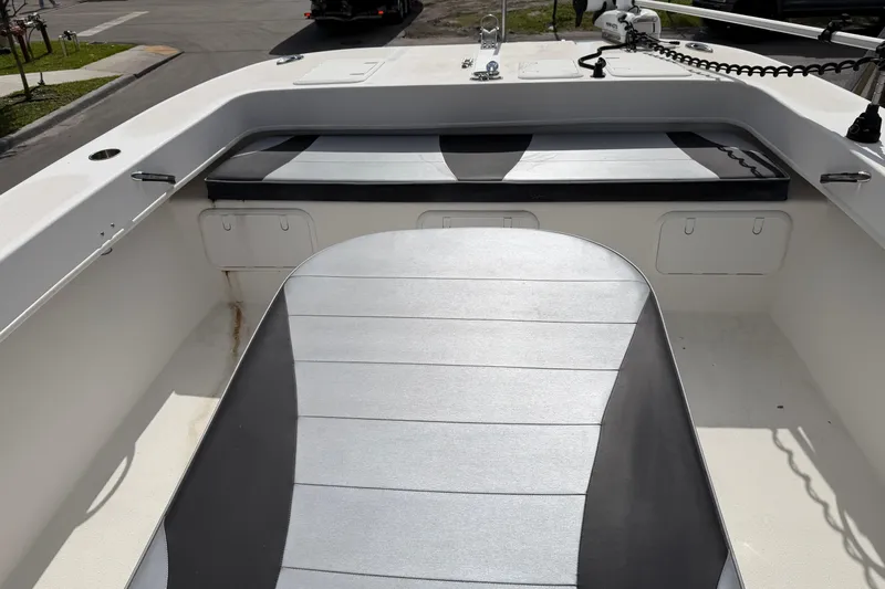  Yacht Photos Pics 2021 Twin Vee 310 CC GF boat interior with cushioned seating and storage compartments.