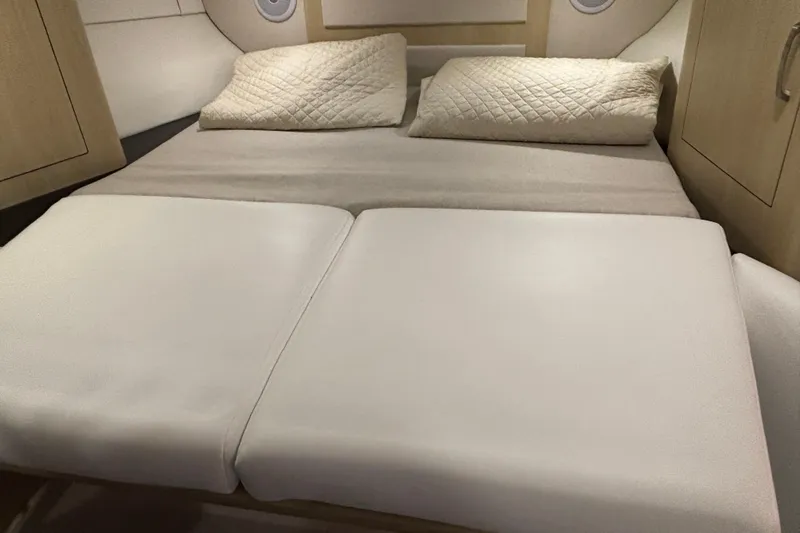  Yacht Photos Pics 2023 Regal 33 Express cabin interior with comfortable bedding and modern design.