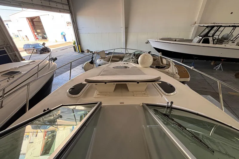  Yacht Photos Pics 2023 Regal 33 Express yacht in a marina storage facility, showcasing sleek design and modern features.