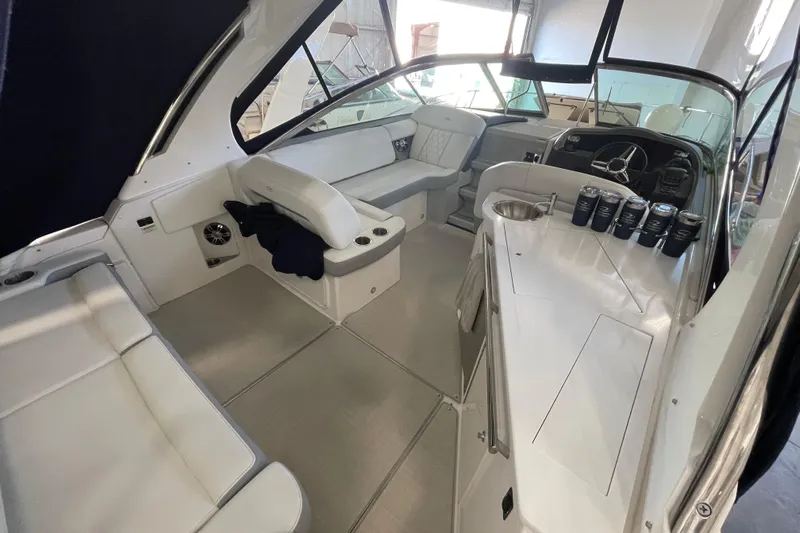  Yacht Photos Pics 2023 Regal 33 Express boat interior with seating, helm, and beverage holders.