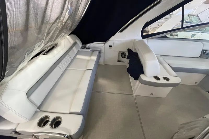  Yacht Photos Pics 2023 Regal 33 Express boat interior with white seating and cup holders.