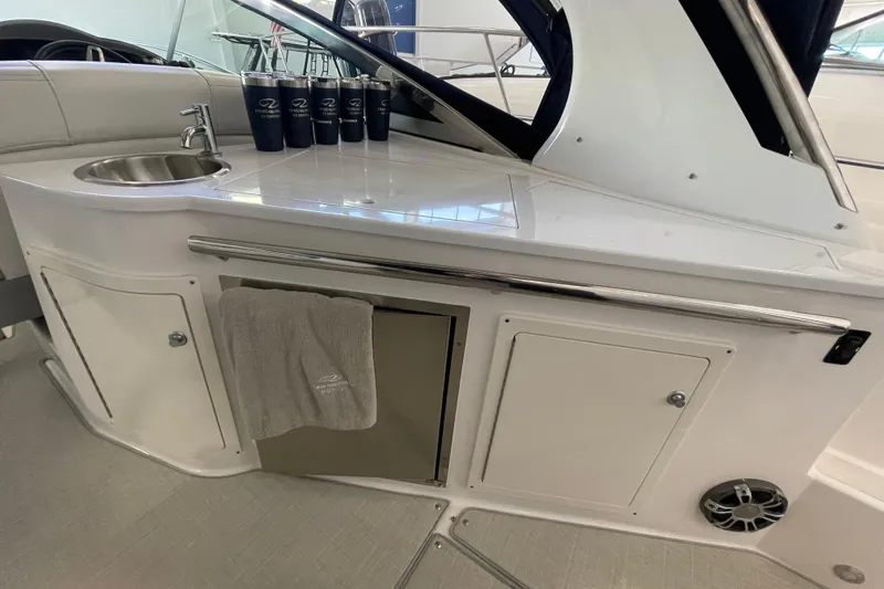  Yacht Photos Pics 2023 Regal 33 Express boat interior with sink, storage, and countertop accessories.