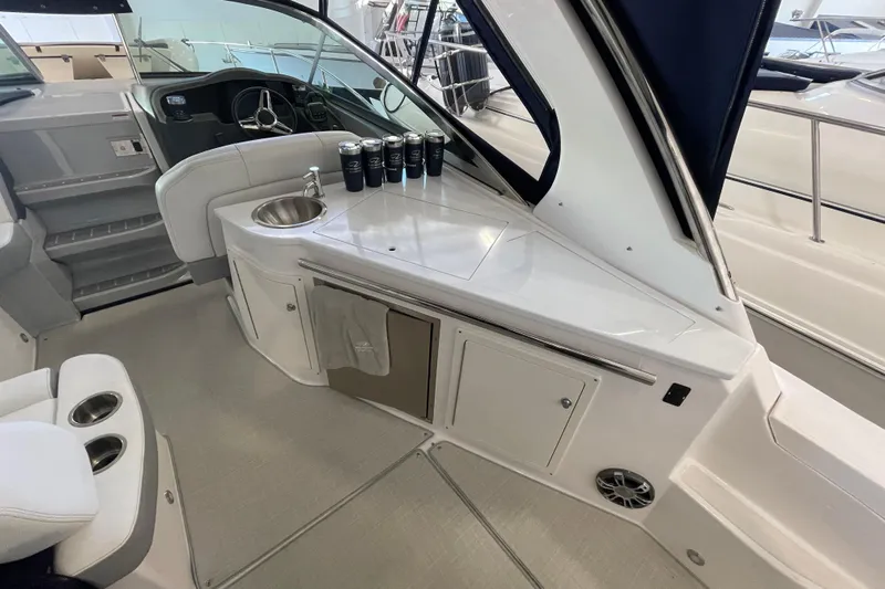  Yacht Photos Pics 2023 Regal 33 Express boat interior with sink, storage, and seating area.