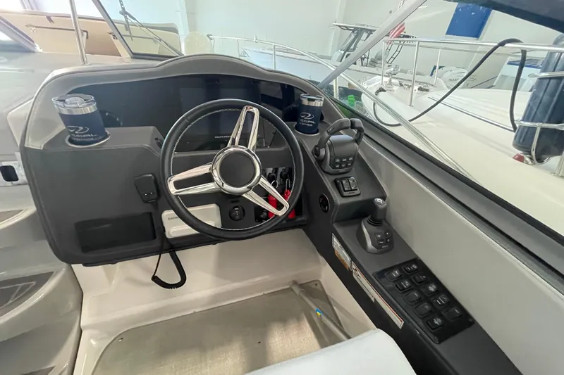  Yacht Photos Pics 2023 Regal 33 Express boat cockpit with steering wheel and control panel.