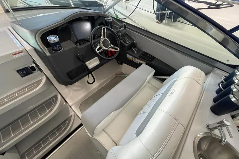  Yacht Photos Pics 2023 Regal 33 Express boat cockpit with steering wheel and modern controls.