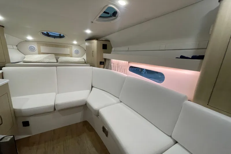 Yacht Photos Pics Luxurious interior of 2023 Regal 33 Express yacht with white seating and ambient lighting.