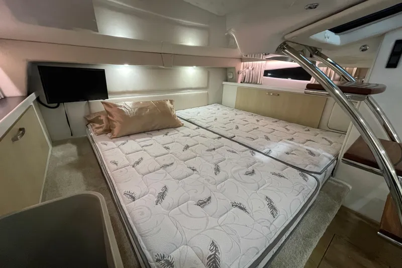  Yacht Photos Pics 2023 Regal 33 Express cabin interior with bed, TV, and modern design elements.