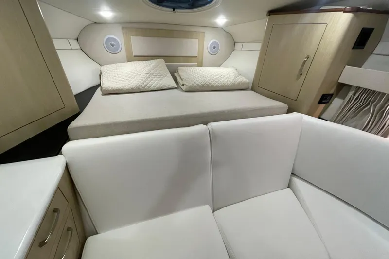  Yacht Photos Pics 2023 Regal 33 Express cabin interior with bed, seating, and storage.