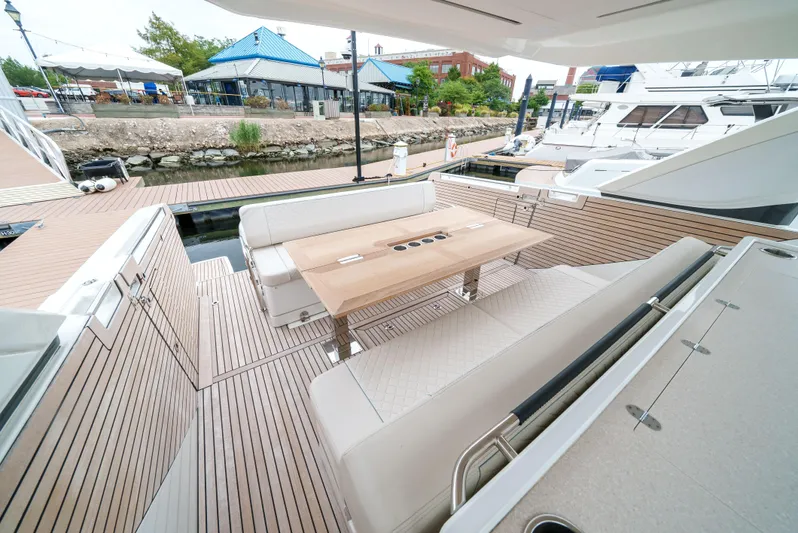  Yacht Photos Pics 2024 Jeanneau DB/43 OB yacht with elegant deck seating and wooden table.