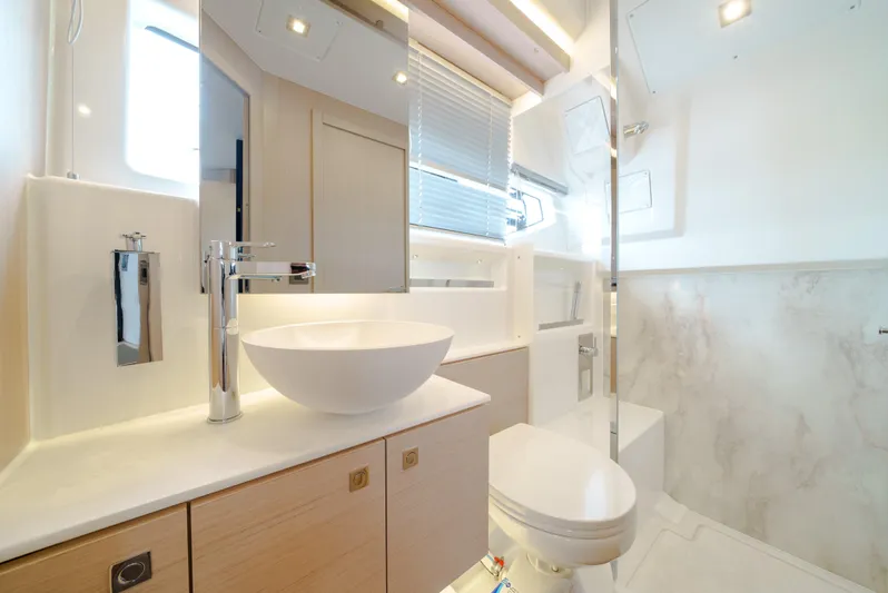  Yacht Photos Pics Luxurious bathroom in 2024 Jeanneau DB/43 OB yacht with modern fixtures and elegant design.