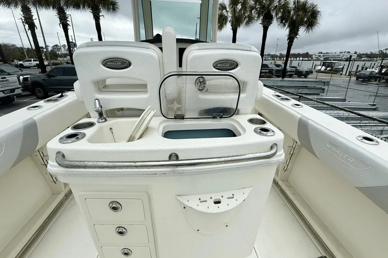  Yacht Photos Pics 2015 Boston Whaler 280 Outrage boat interior with fishing station and storage compartments.