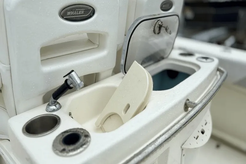  Yacht Photos Pics 2015 Boston Whaler 280 Outrage boat sink and storage area, featuring faucet and compartments.
