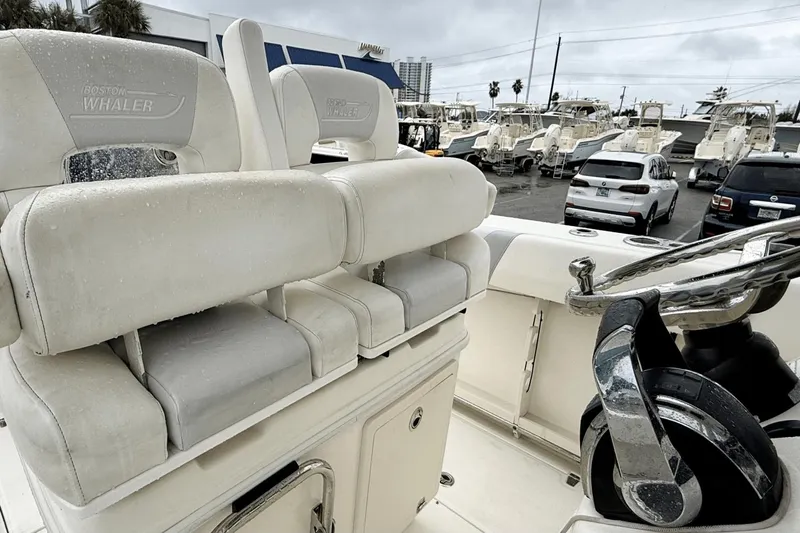  Yacht Photos Pics 2015 Boston Whaler 280 Outrage boat interior with white seating and steering wheel.