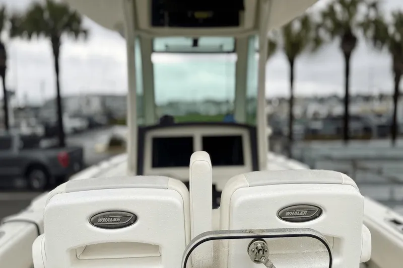  Yacht Photos Pics 2015 Boston Whaler 280 Outrage boat seats with logo, marina background.