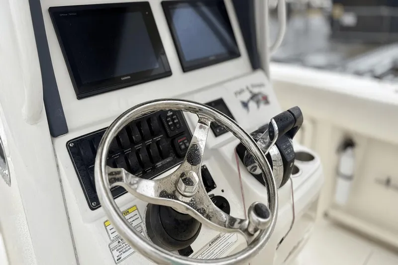  Yacht Photos Pics 2015 Boston Whaler 280 Outrage helm with steering wheel and navigation screens.