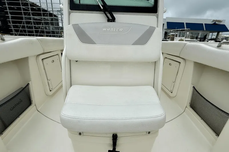  Yacht Photos Pics 2015 Boston Whaler 280 Outrage boat interior with cushioned seating and storage compartments.
