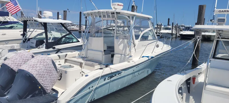 Dos Suenos Yacht Photos Pics 2015 Century 30 boat docked at marina, featuring dual outboard motors and sleek design.